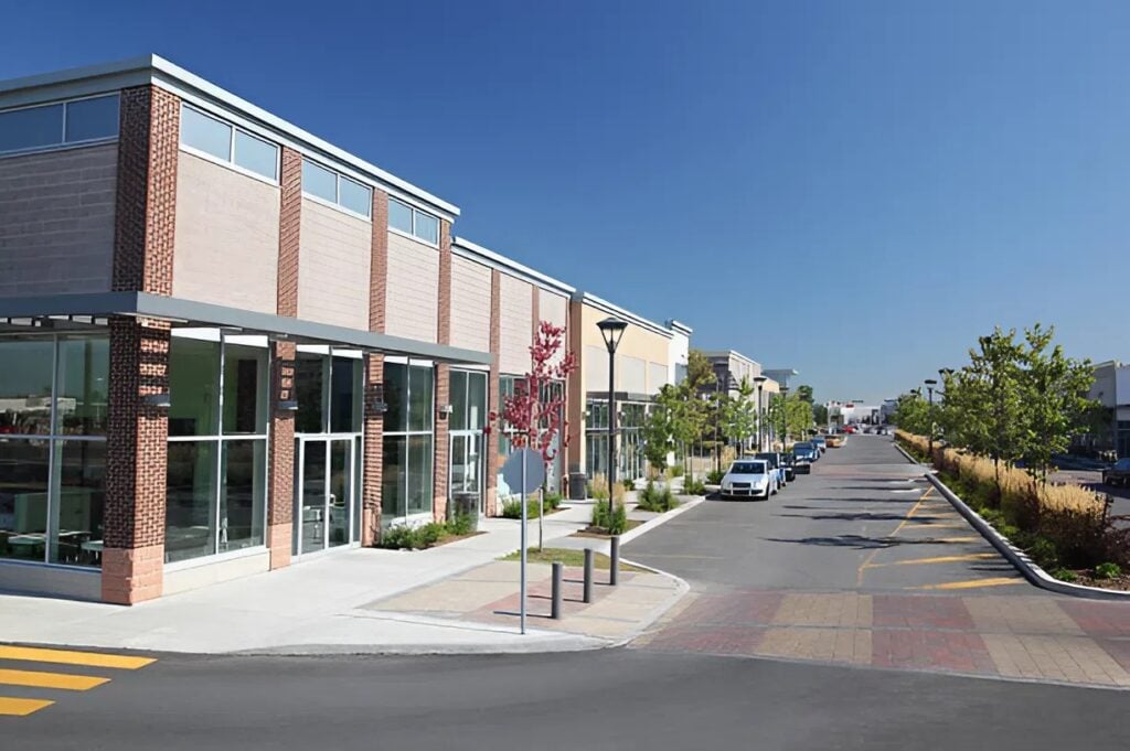 Commercial plaza with freshly painted exterior showing weather-resistant work by an exterior painter in New London, NH