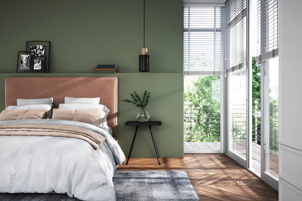 Bedroom with a green accent wall painted by a house painter in New London, NH