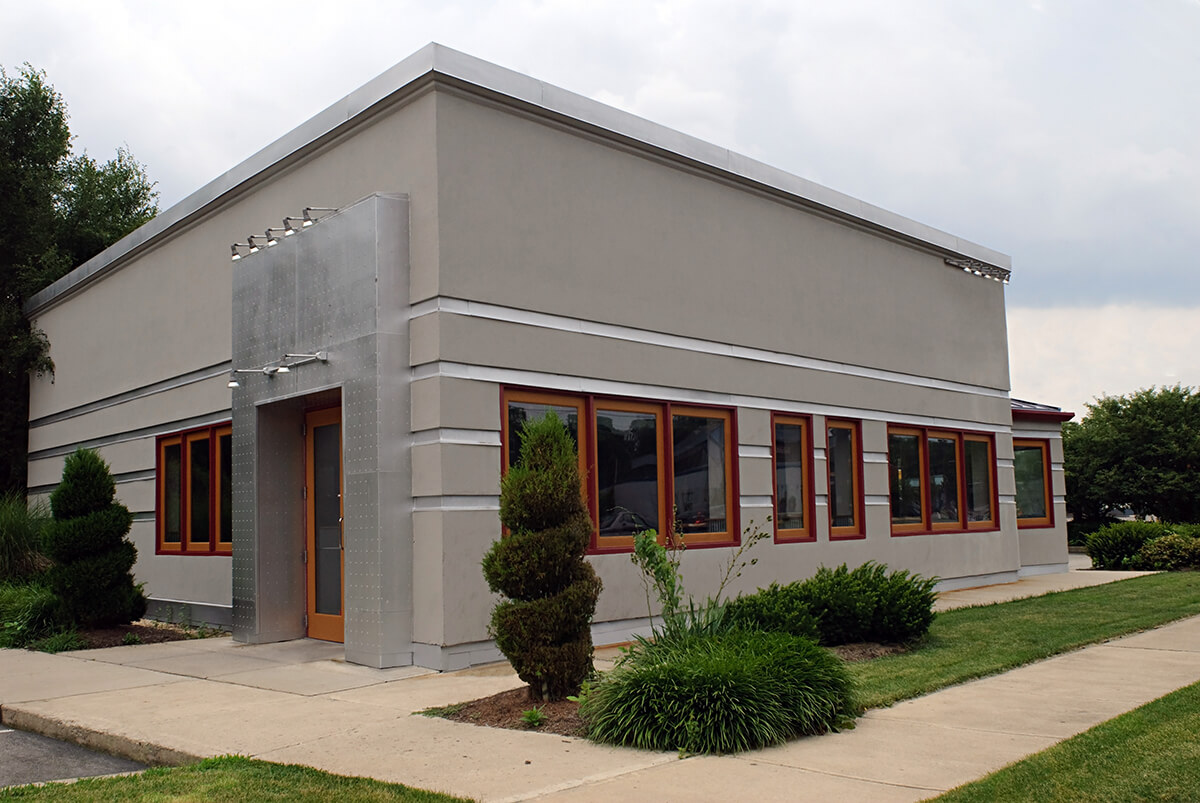 Commercial building with clean, neutral exterior finish and updated trim details by an exterior painter in Sunapee, NH