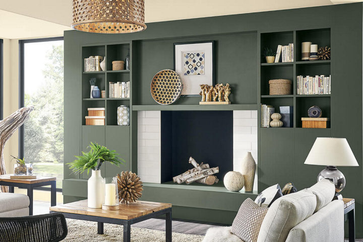 Dark olive green living room with crisp trims by an interior painter in Woodstock, VT.