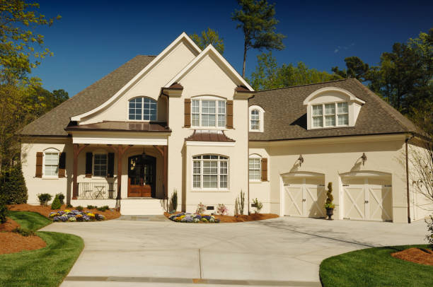 Home with cream-painted siding, warm beige exterior, and a UV-resistant finish by an exterior painter in Newbury, NH