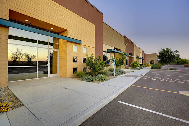 Commercial exterior with warm tan, golden-beige siding, and concrete finishes by an exterior painter in Newbury, MI.