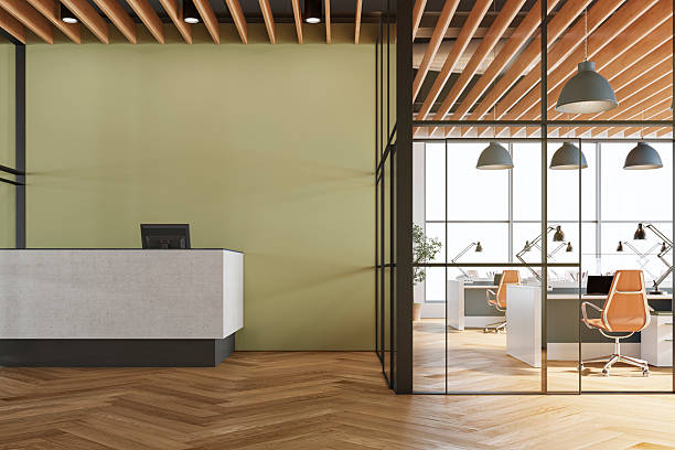 Reception area with a muted sage green accent wall and warm wood finishes by an interior painter in Quechee, VT.